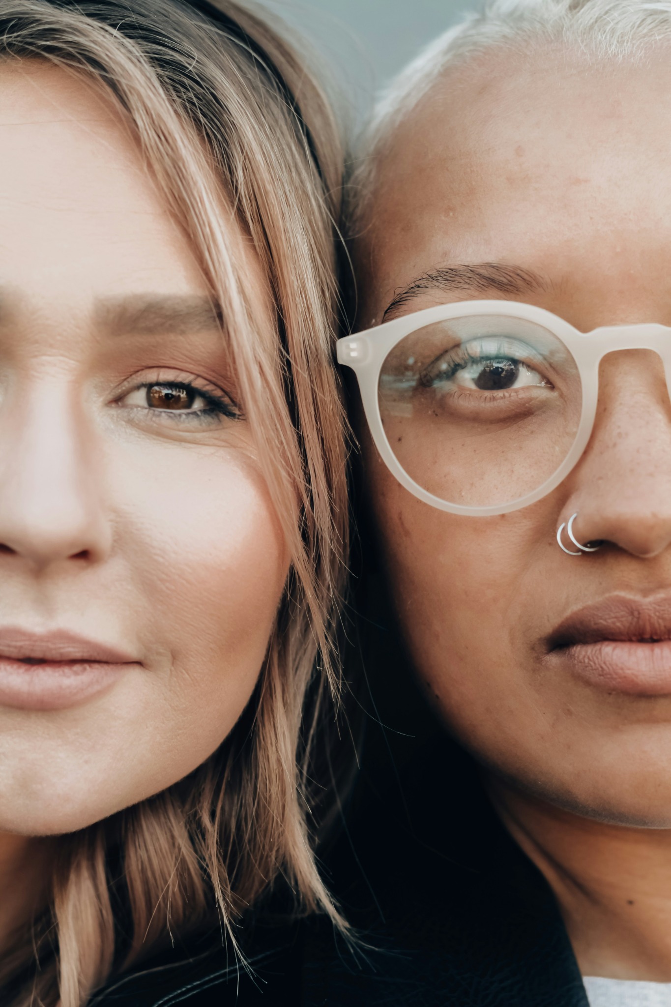 Two queer partners close together in an intimate portrait